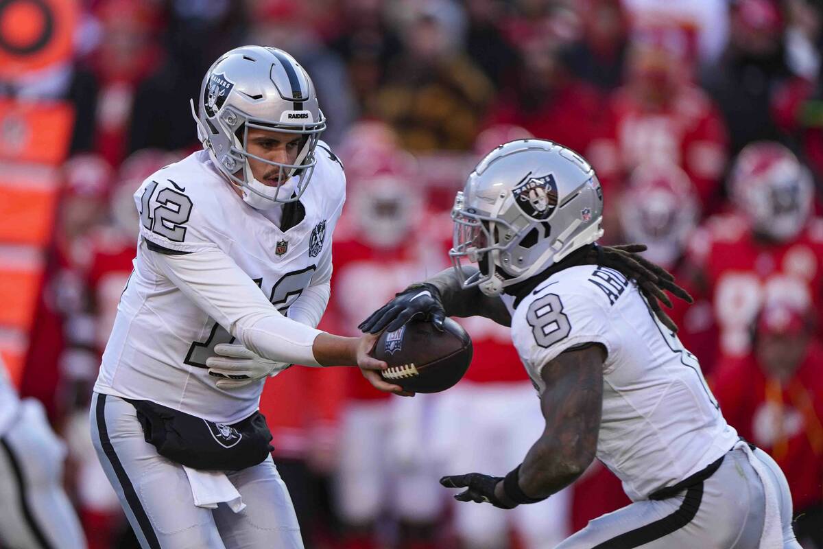 Las Vegas Raiders quarterback Aidan O'Connell (12) hands off to running back Ameer Abdullah (8) ...