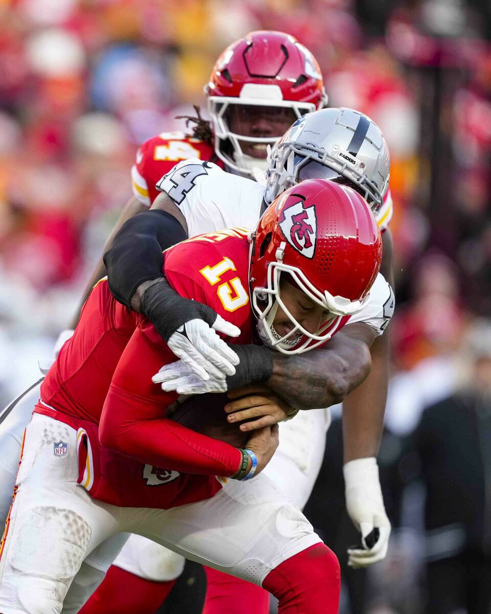 Kansas City Chiefs quarterback Patrick Mahomes (15) is sacked by Las Vegas Raiders defensive en ...