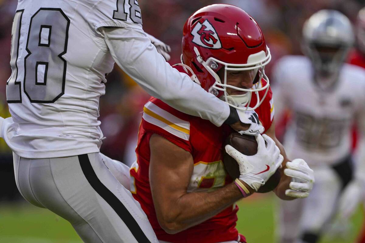 Kansas City Chiefs wide receiver Justin Watson (84) is hit by Las Vegas Raiders cornerback Jack ...