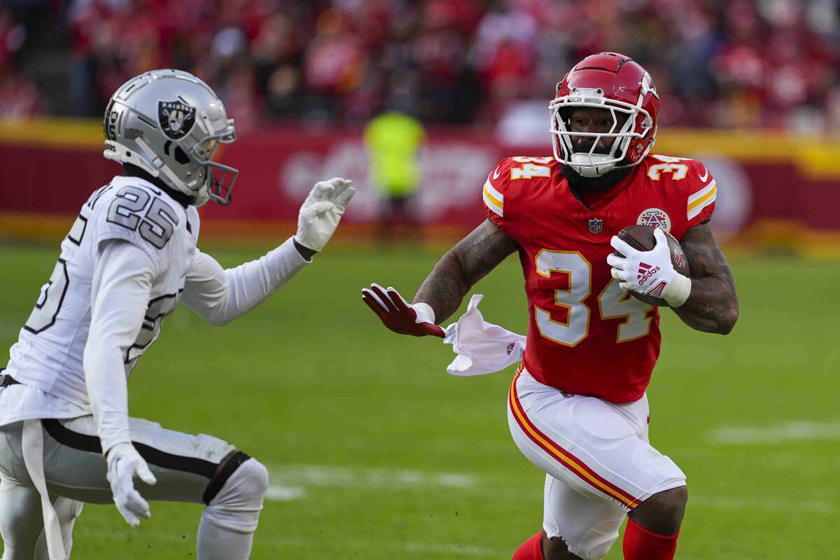 Kansas City Chiefs running back Samaje Perine (34) runs past Las Vegas Raiders cornerback Decam ...