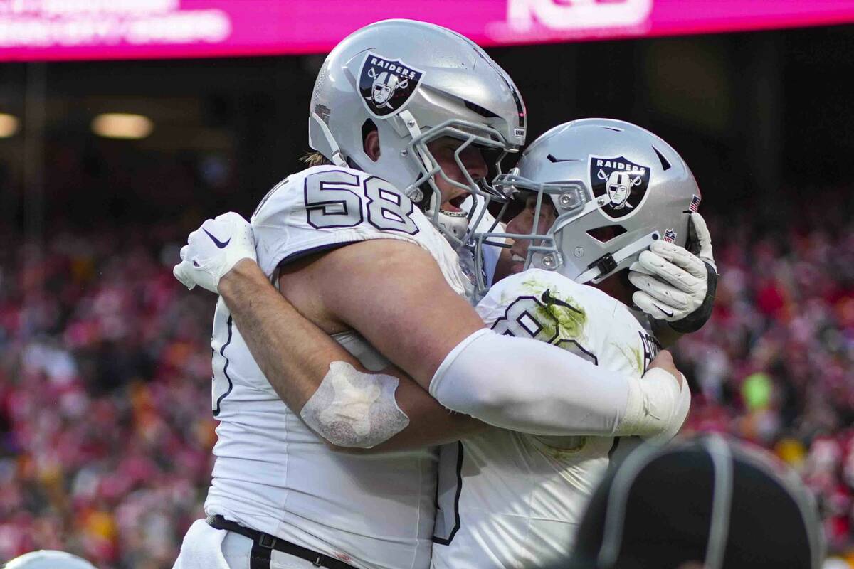 Las Vegas Raiders tight end Brock Bowers, right, celebrates his touchdown with guard Jackson P ...