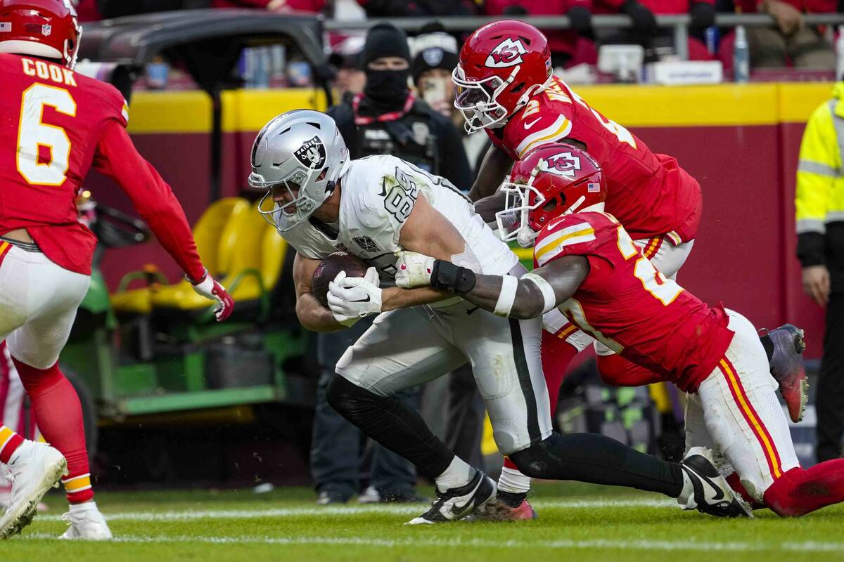 Las Vegas Raiders tight end Brock Bowers (89) scores a touchdown as he's hit by Kansas City Chi ...