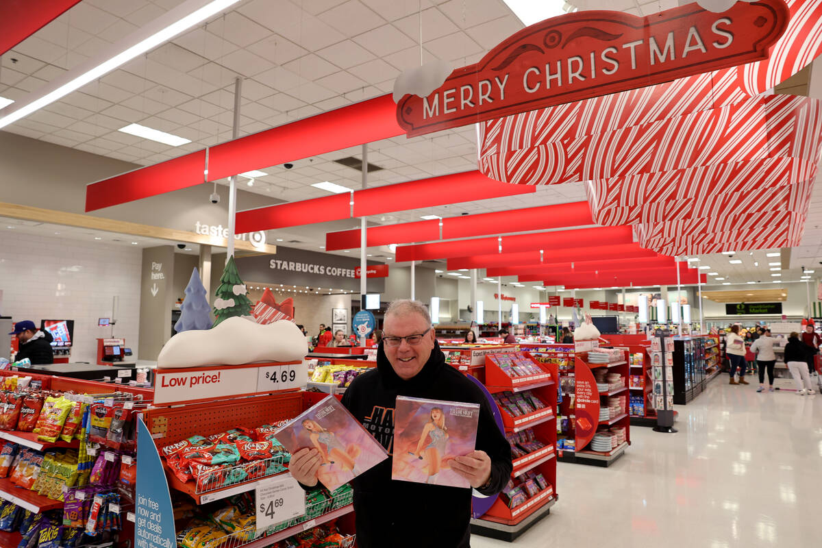 Black Friday shopper Tom Hardy of Henderson shows his Taylor Swift Eras Tour books just after t ...