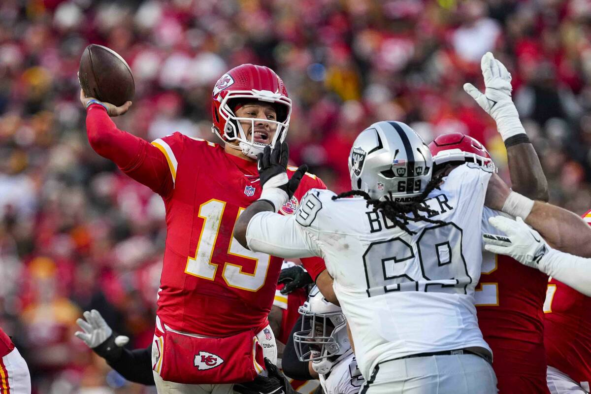 Kansas City Chiefs quarterback Patrick Mahomes (15) throws over Las Vegas Raiders defensive tac ...