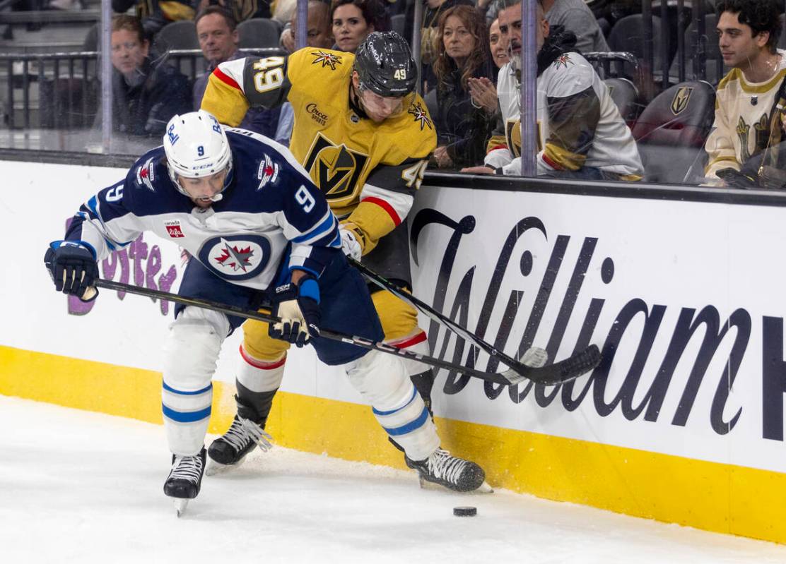 Winnipeg Jets left wing Alex Iafallo (9) and Golden Knights center Ivan Barbashev (49) compete ...