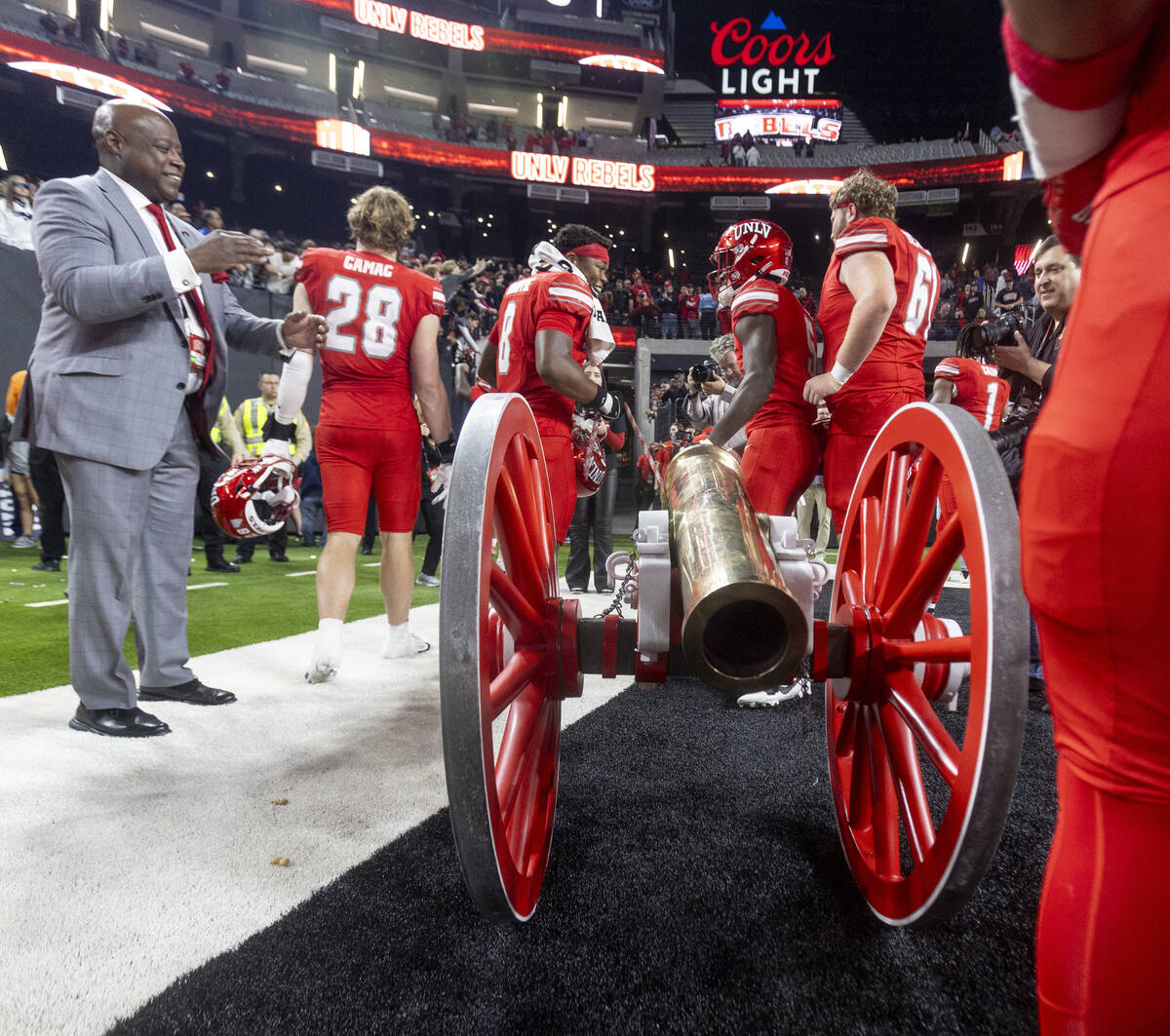 UNLV players wheel the Fremont Cannon to the locker room after winning the NCAA college footbal ...