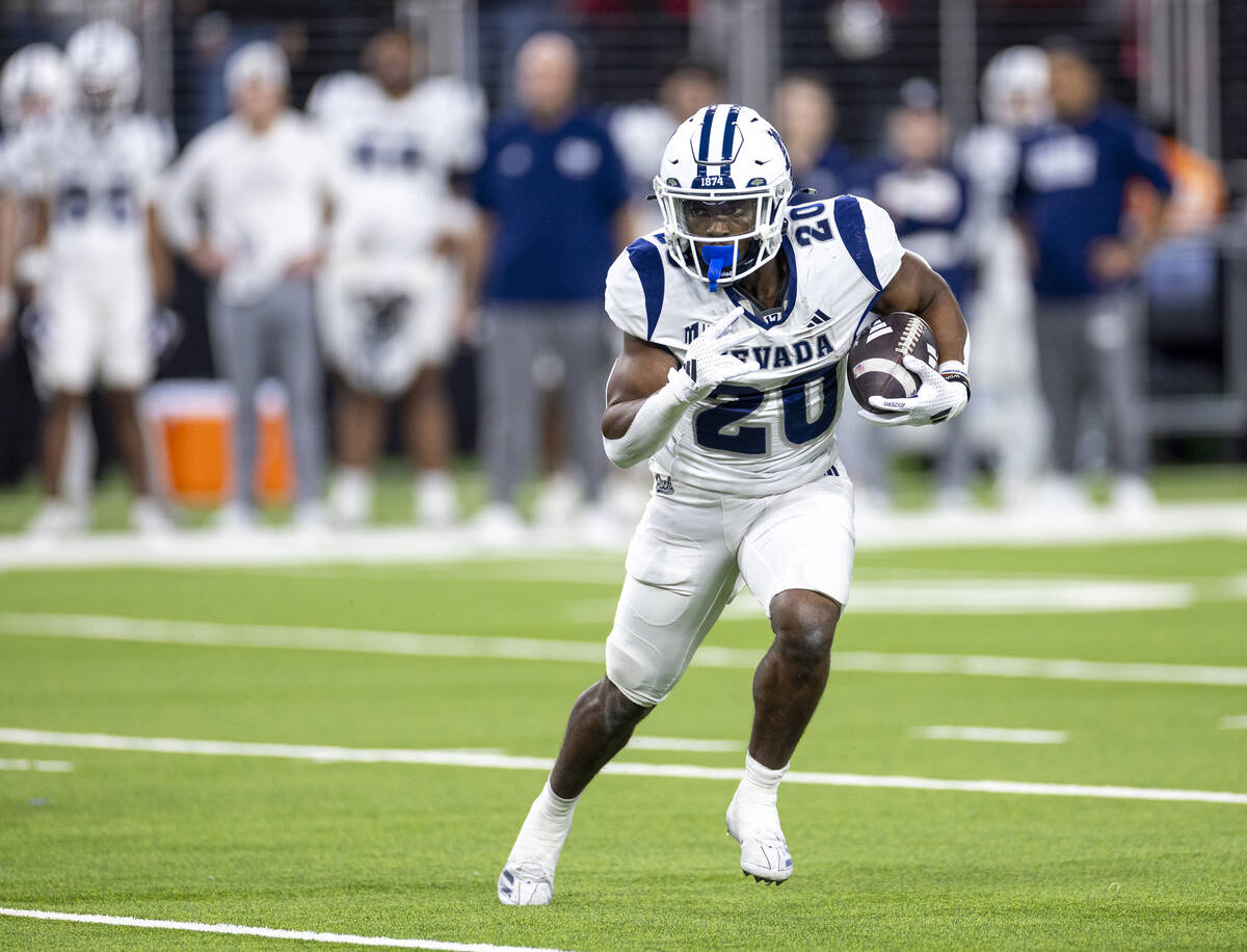 UNR running back Caleb Ramseur (20) runs with the ball during the NCAA college football game ag ...