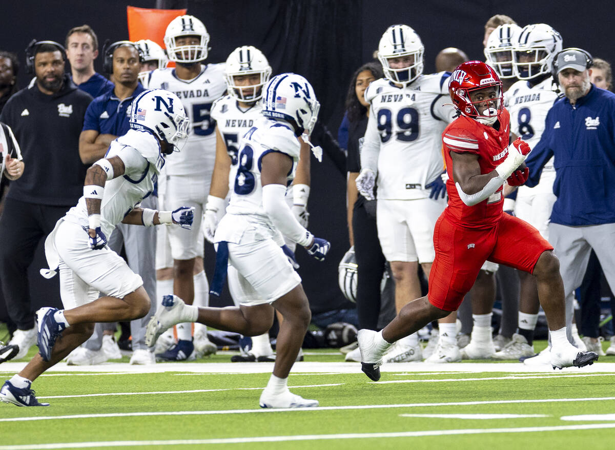 UNLV running back Kylin James, right, runs with the ball during the NCAA college football game ...