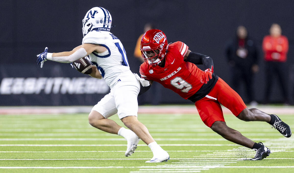 UNLV defensive back Jett Elad (9) attempts to tackle UNR wide receiver Marcus Bellon, left, dur ...