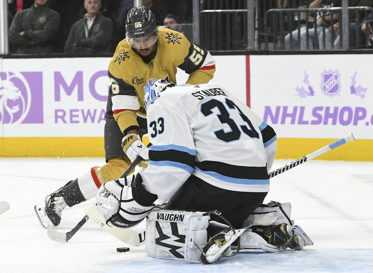 Utah Hockey Club goaltender Jaxson Stauber (33) stops a shot by Vegas Golden Knights right wing ...