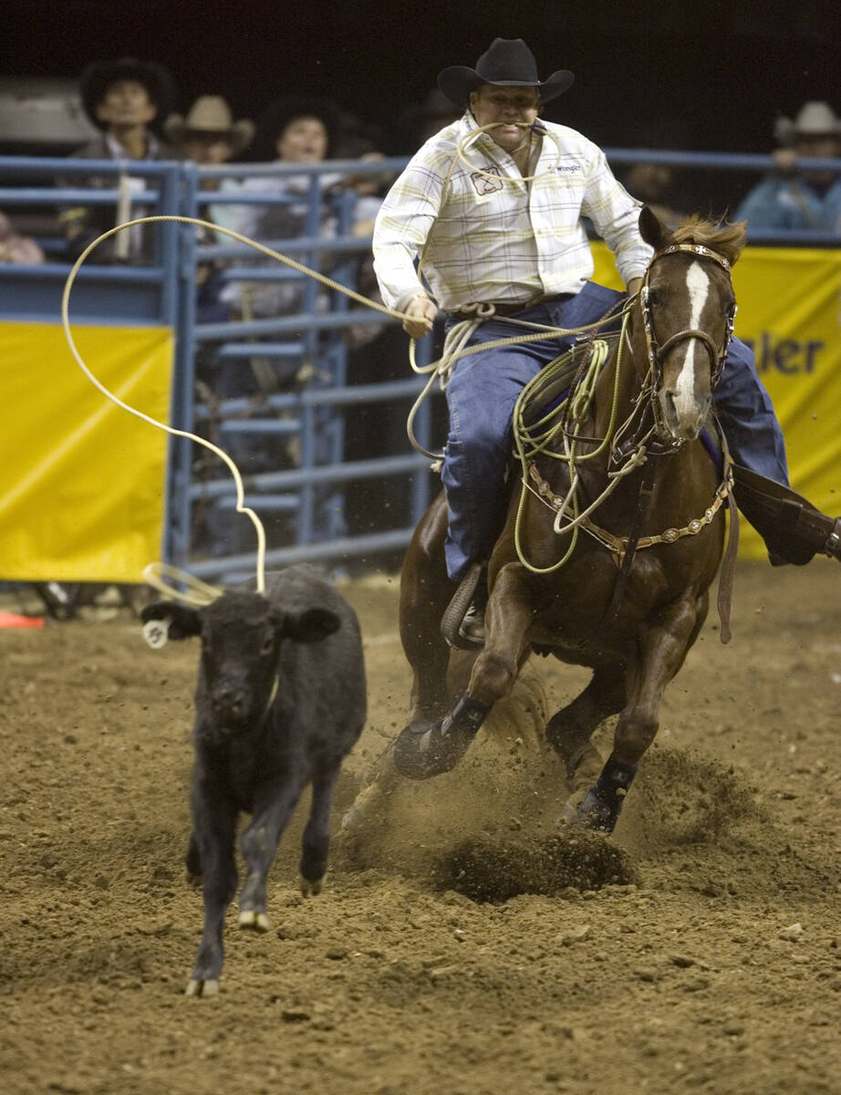 Joe Beaver of Huntsville, Texas, ropes a calf in a time of 7.7 seconds to take first place for ...