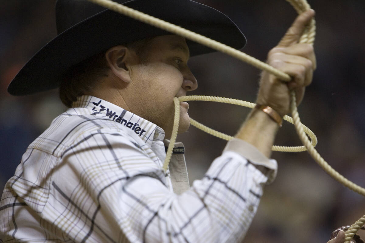 Professional calf roper Joe Beaver competes in the calf roping event during round two of the 48 ...