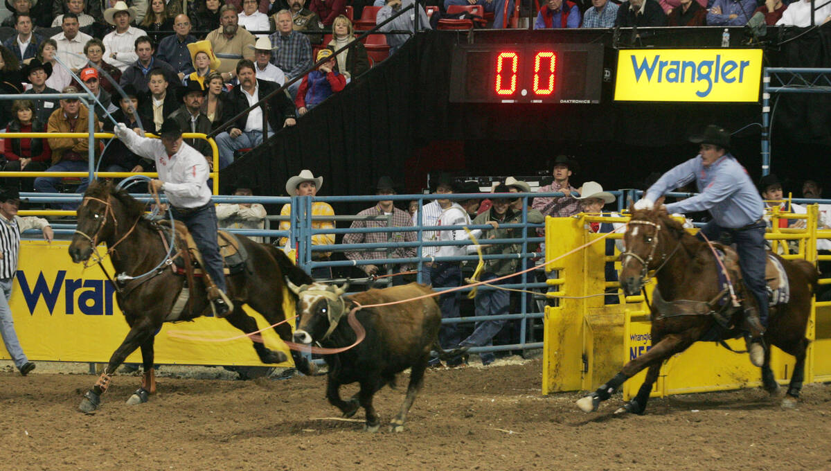 Team ropers, Rich Skelton, left, and Speed Williams during their round three performance Sunday ...