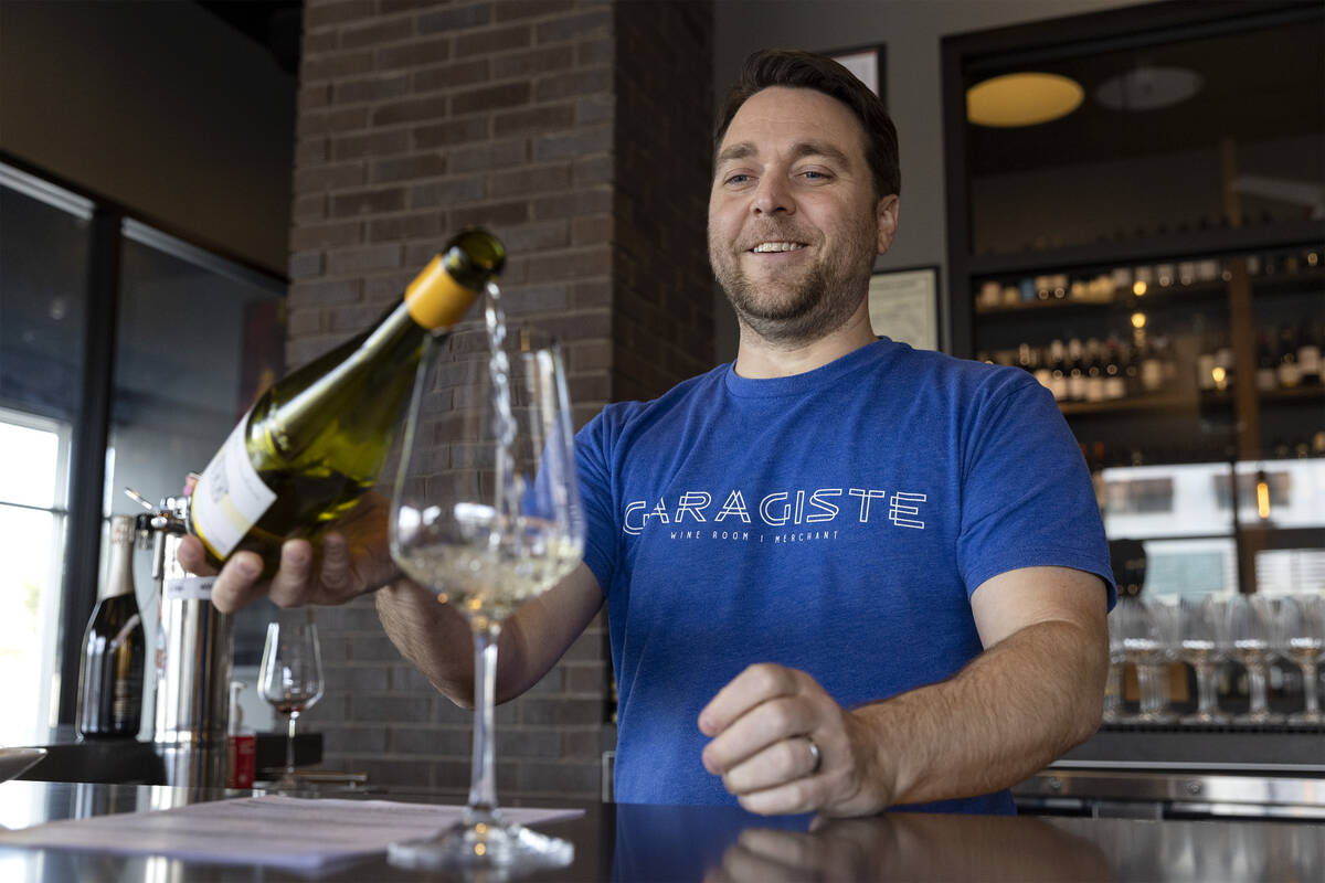 Sommelier and owner of Garagiste, Eric Prato, pours a glass of wine for a guest at the downtown ...