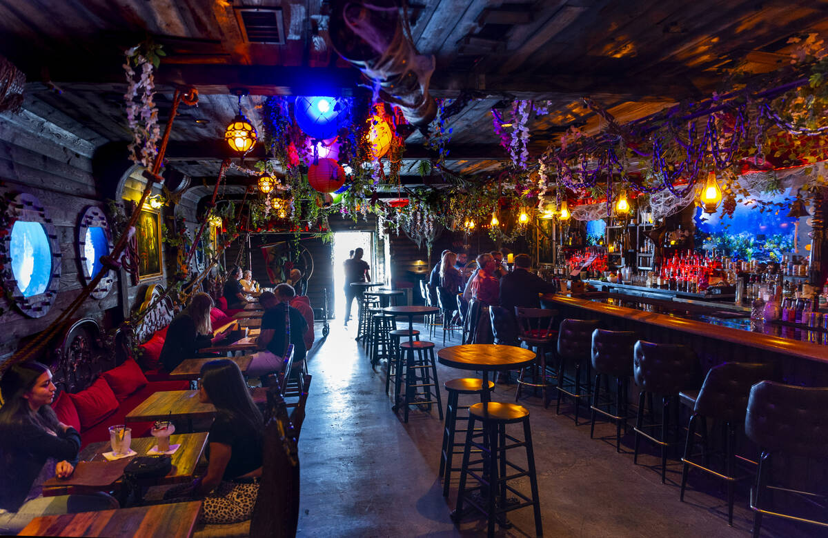 More customers enter the dog/pirate themed tiki bar Stray Pirate in the art's district on Frida ...