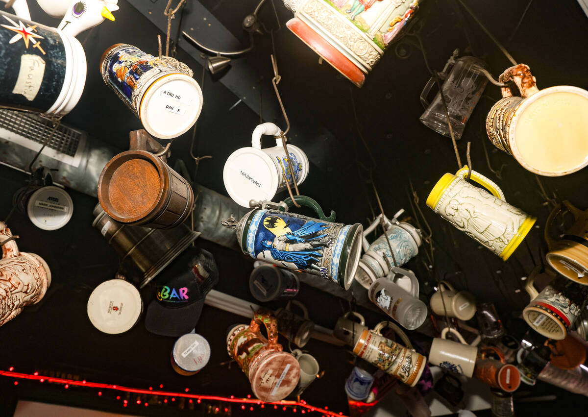 Customers’ beer steins hang from the ceiling at ReBAR, a thrift store-meets-dive-bar in ...