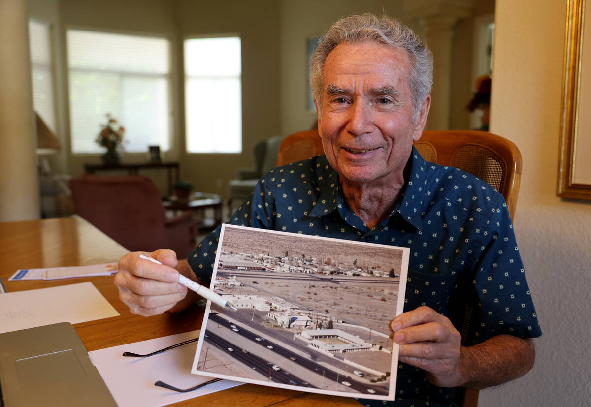 Henderson Historical Society member Rick Watson shows a 1970s photo of the northeast intersecti ...