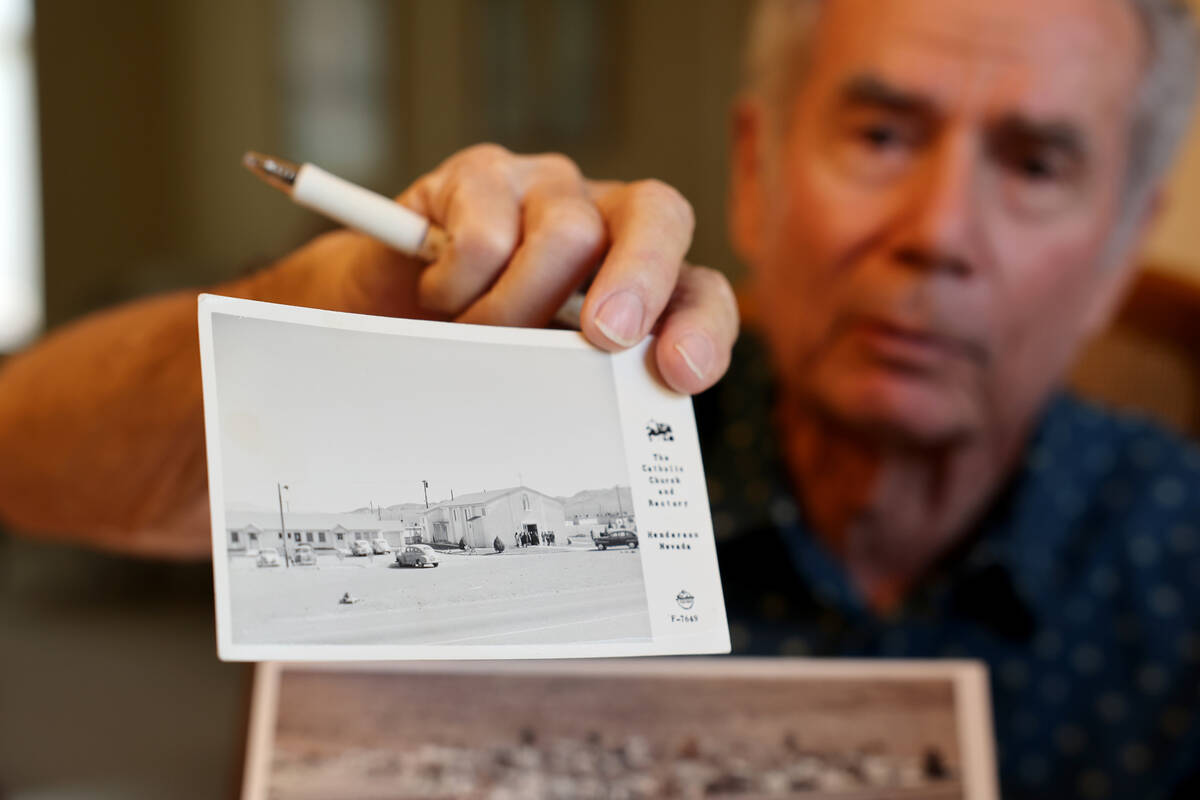 Henderson Historical Society member Rick Watson shows a postcard with the original St. Peter’ ...