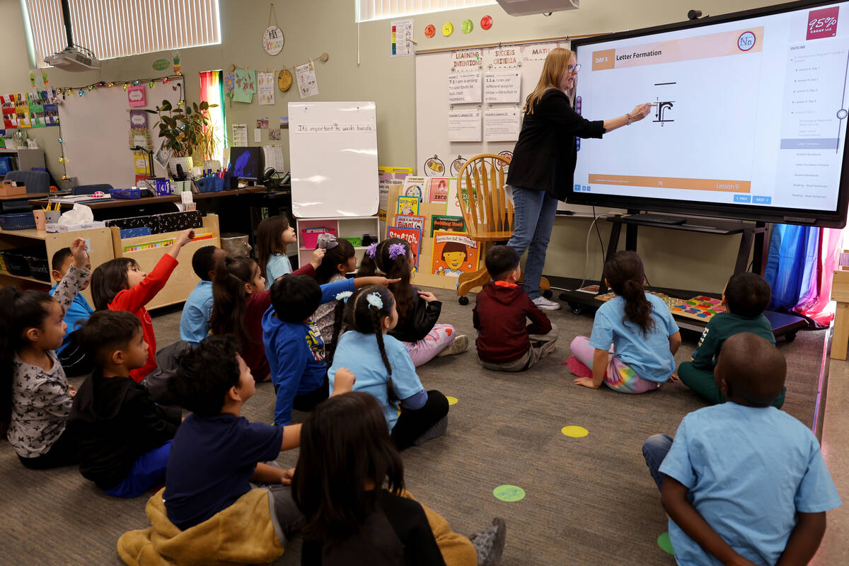 Kinder Dual Language English teacher Linda Krenn works with kindergartners at Lake Elementary S ...