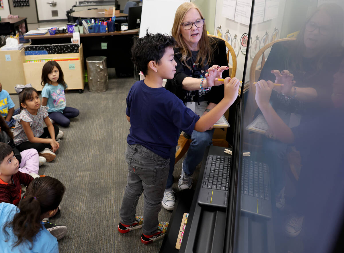 Kindergartner Marcos Alvizo learns with Kinder Dual Language English teacher Linda Krenn at Lak ...