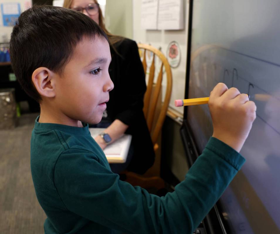 Kindergartner Brandon Delgadillo learns with Kinder Dual Language English teacher Linda Krenn a ...