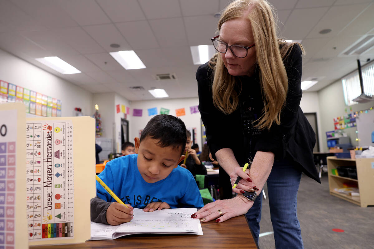 Kindergartner Jose Mayen Hernandez learns with Kinder Dual Language English teacher Linda Krenn ...