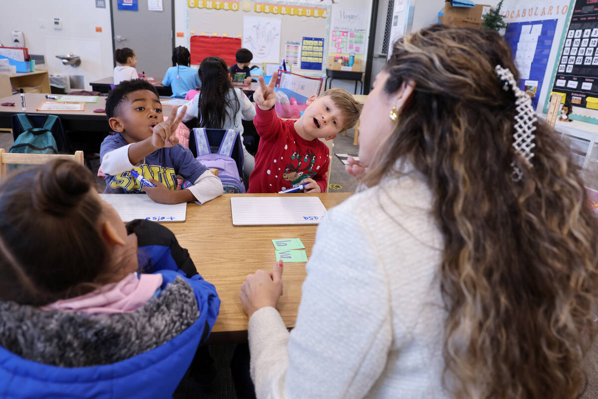 Student teacher Cinthia Garcia works with, from left, Samantha Leyva De La Vega, Justice Willia ...