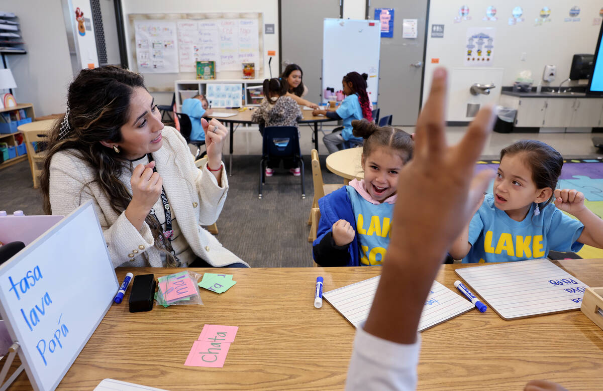 Student teacher Cinthia Garcia works with Samantha Leyva De La Vega, left, and Olivia Alvarez L ...