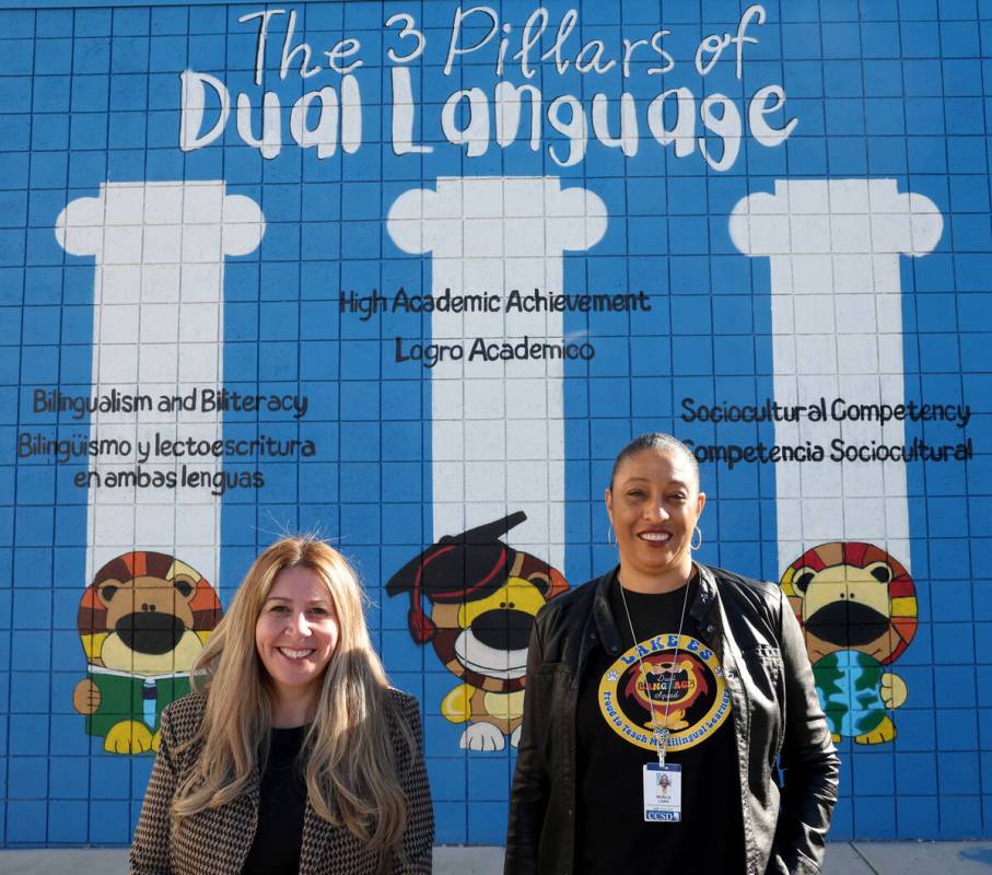 Principal Paola Zepher, left, and School Associate Superintendent Monica Lang pose with a dual ...