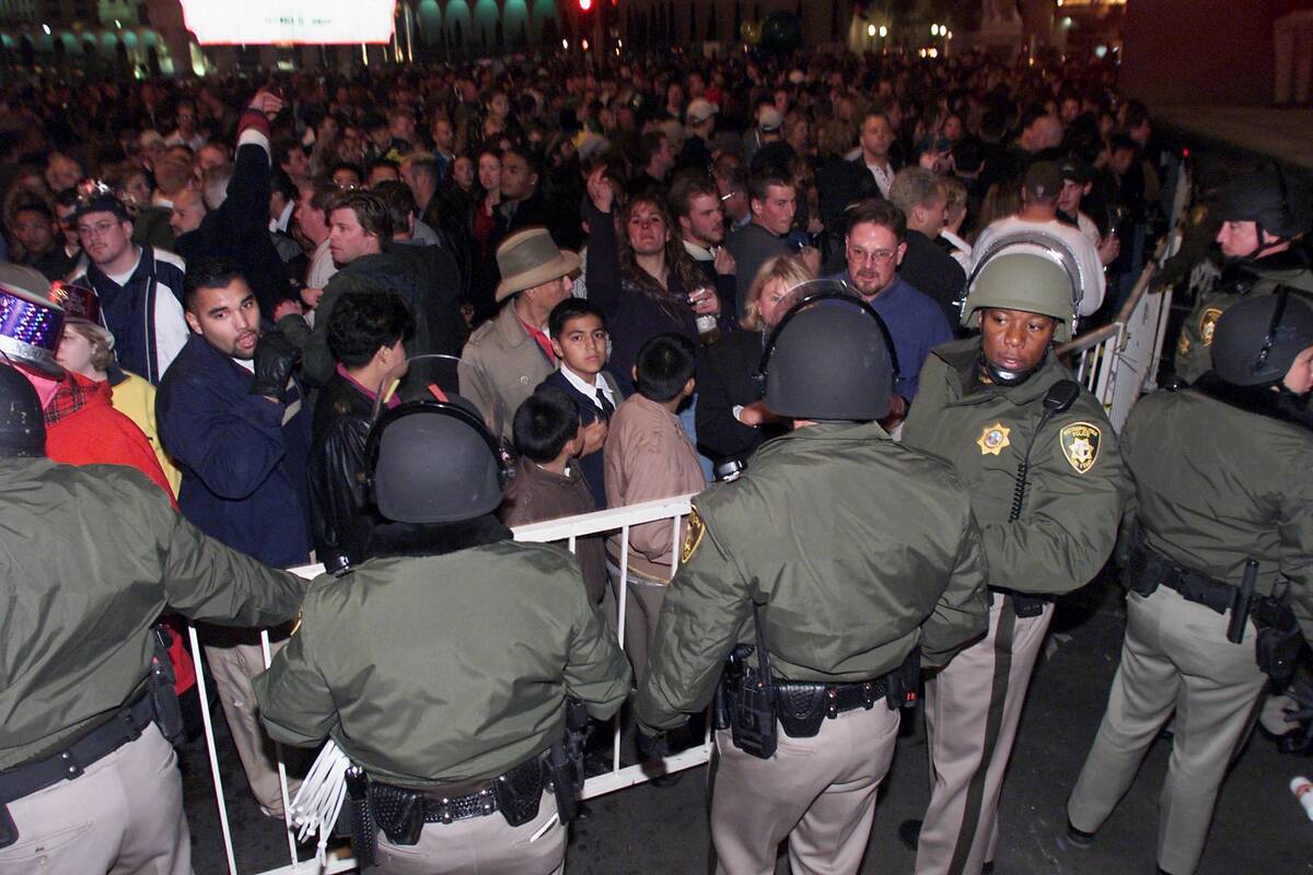 Metro officers stand guard behind baricades on the Strip at a closed alley just north of the Fl ...