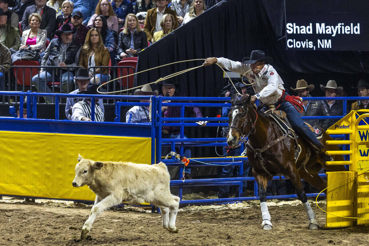 Shad Mayfield eyes his calf in Tie-Down Roping during day 6 action of the NFR at the Thomas &am ...