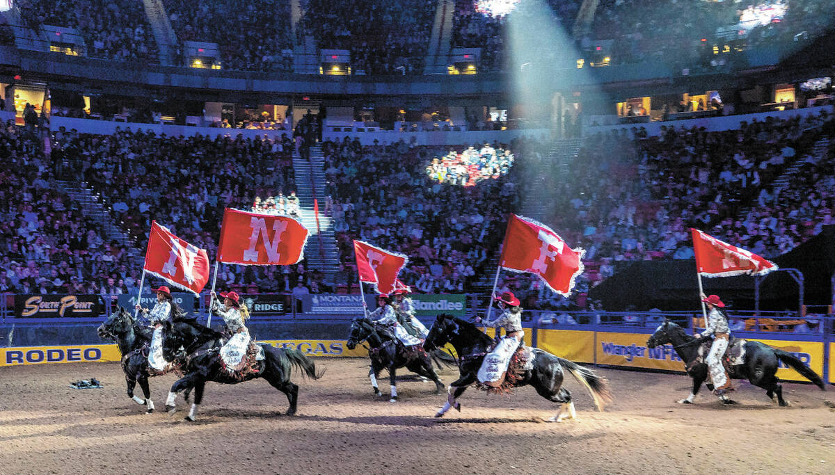 Riders carry flat as they welcome fans during day 6 action of the NFR at the Thomas & Mack ...