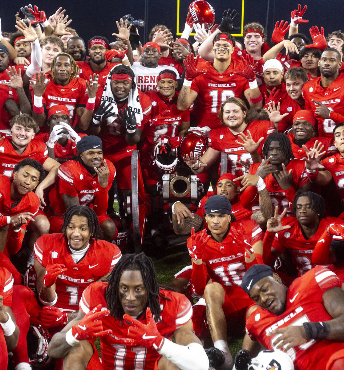 UNLV poses with the Fremont Cannon after winning the NCAA college football game against UNR 38- ...