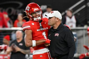 UNLV wide receiver Casey Cain (1) and head coach Barry Odom greet each other before an NCAA col ...