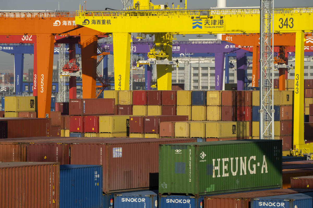 FILE - Shipping containers are stacked at a port in Tianjin, China, Jan. 16, 2023. (AP Photo/Ma ...