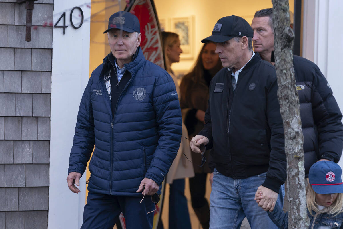 President Joe Biden and son Hunter Biden walk in downtown Nantucket Mass., Friday, Nov. 29, 202 ...