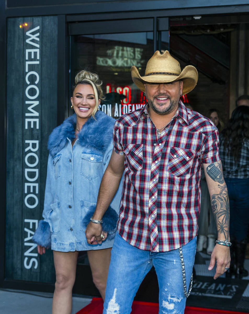 Jason Aldean arrives outside with his wife Brittany as they and the TC Restaurant Group celebra ...