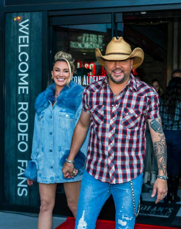 Jason Aldean arrives outside with his wife Brittany as they and the TC Restaurant Group celebra ...