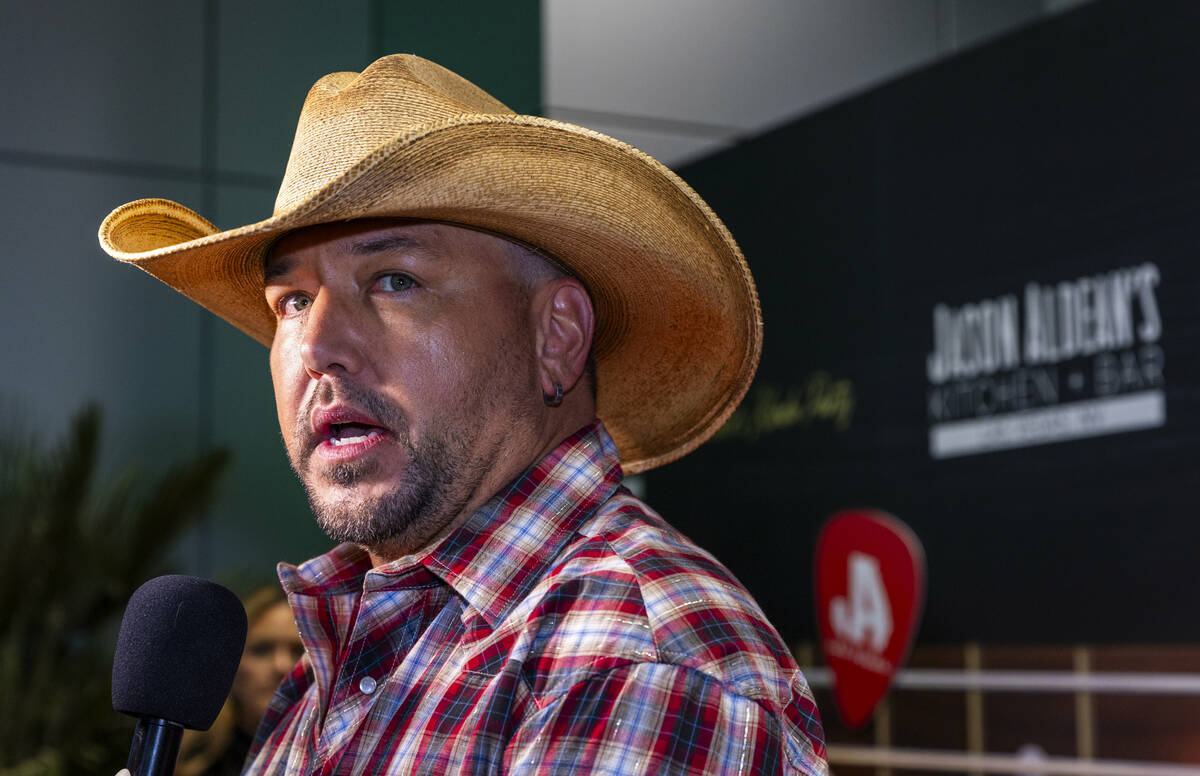 Jason Aldean stops for an interview as he and the TC Restaurant Group celebrate the grand openi ...