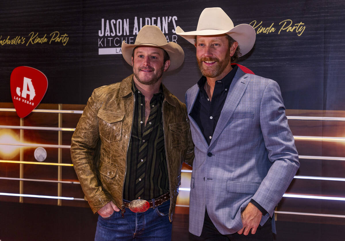 Easton Corbin and Chancey Williams stop together while walking the red carpet as Jason Aldean a ...