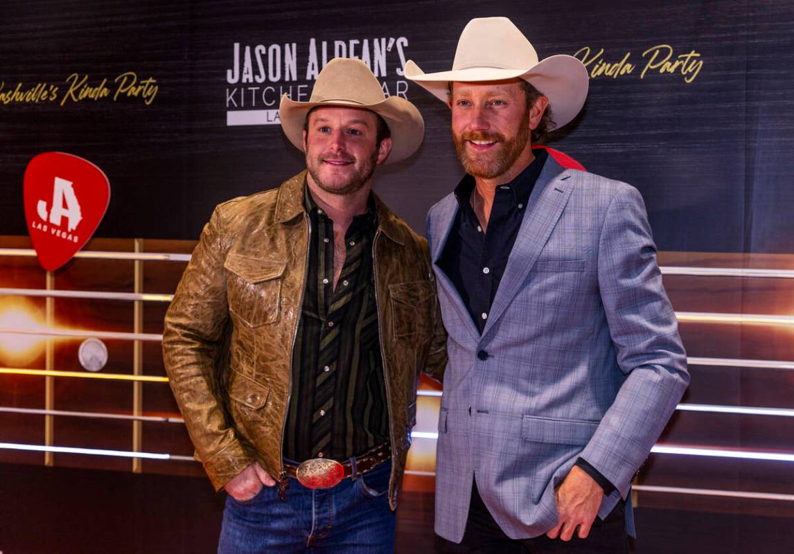 Easton Corbin and Chancey Williams stop together while walking the red carpet as Jason Aldean a ...