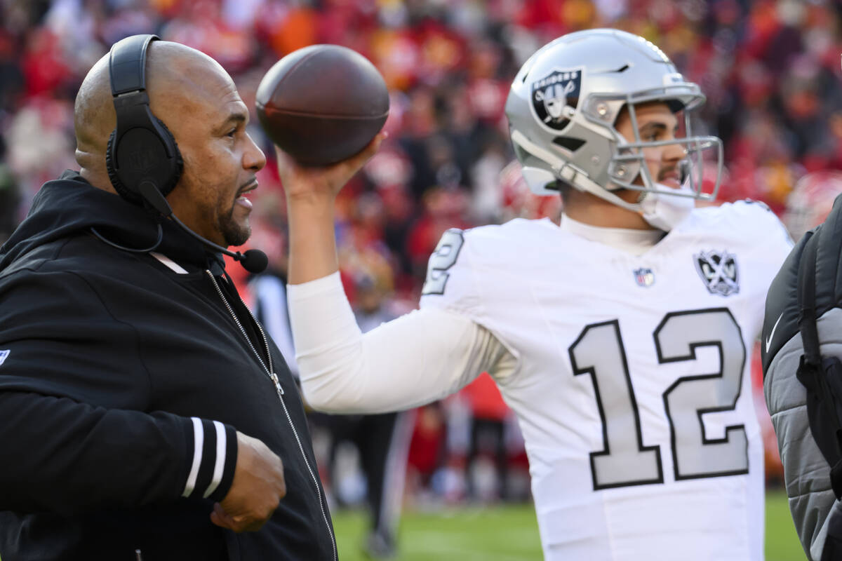 Las Vegas Raiders head coach Antonio Pierce, left, watches Raiders quarterback Aidan O'Connell ...