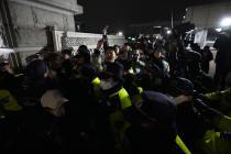 Police officers stand guard in front of the National Assembly in Seoul, South Korea, Tuesday, D ...