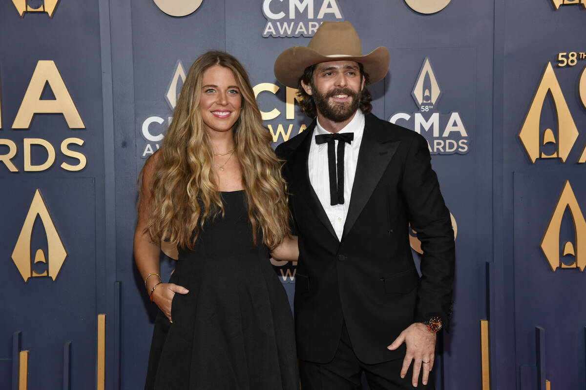 Lauren Akins, left, and Thomas Rhett arrive at the 58th Annual CMA Awards on Wednesday, Nov. 20 ...