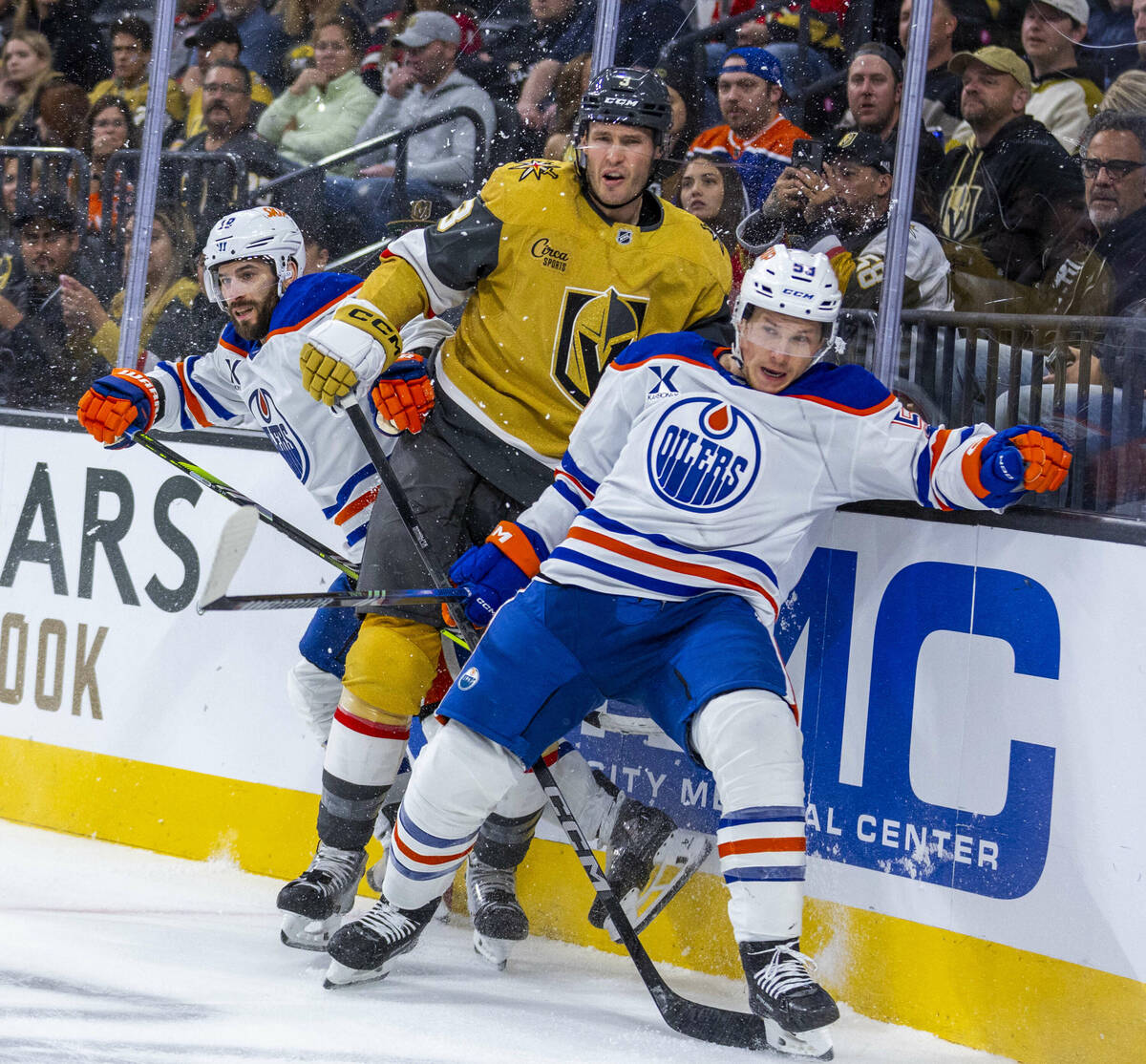 Golden Knights defenseman Brayden McNabb (3) is sandwiched between Edmonton Oilers center Jeff ...