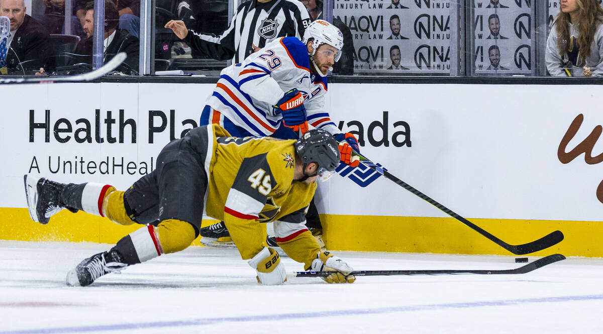 Golden Knights center Ivan Barbashev (49) goes to the ice while still chasing a puck controlled ...