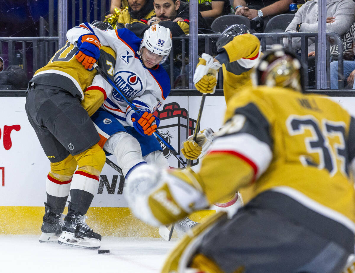 Golden Knights left wing Tanner Pearson (70) and Oilers right wing Vasily Podkolzin (92) battle ...