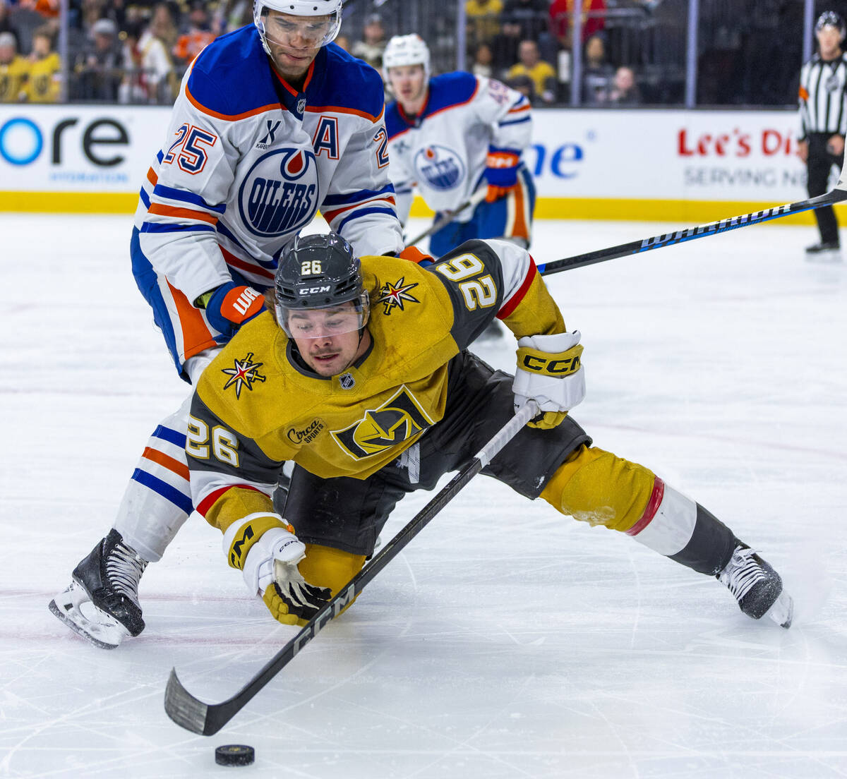 Golden Knights right wing Alexander Holtz (26) keeps control of the puck away from Edmonton Oil ...