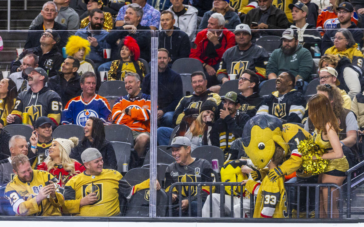 Chance the Gila Monster bits the head of a young fan as time winds down against the Edmonton Oi ...