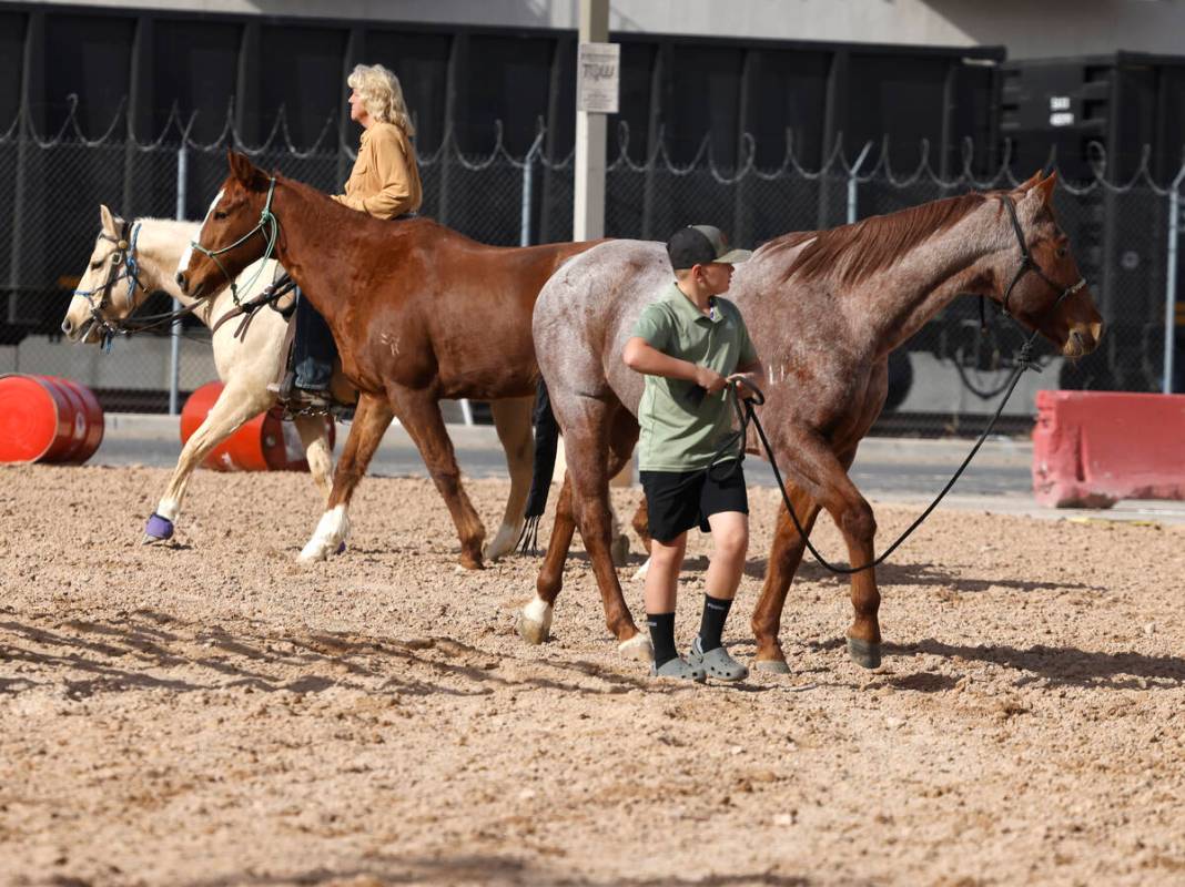 Monique Michel of Las Vegas, left, and Gage Pressinger, 10, warm up their horses at the Core Ar ...